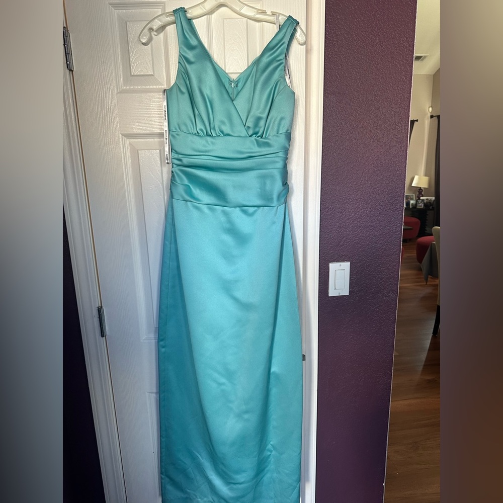 Woman’s teal strapless prom or bridesmaid dress.